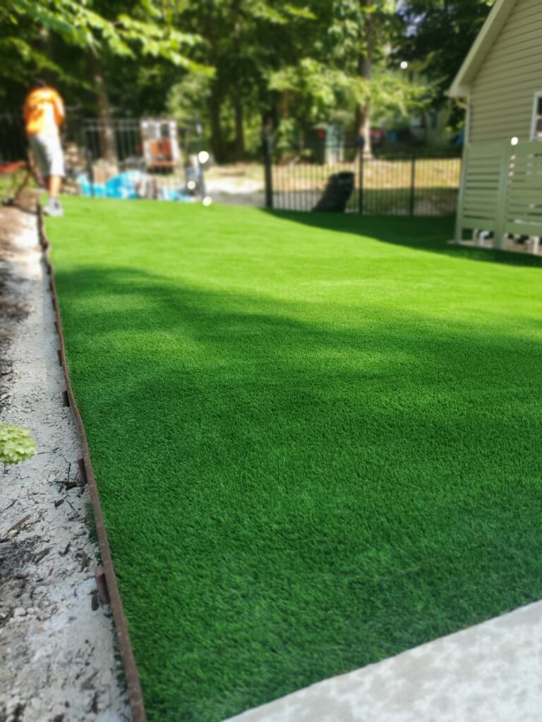 Artificial turf lawn installed in a residential backyard