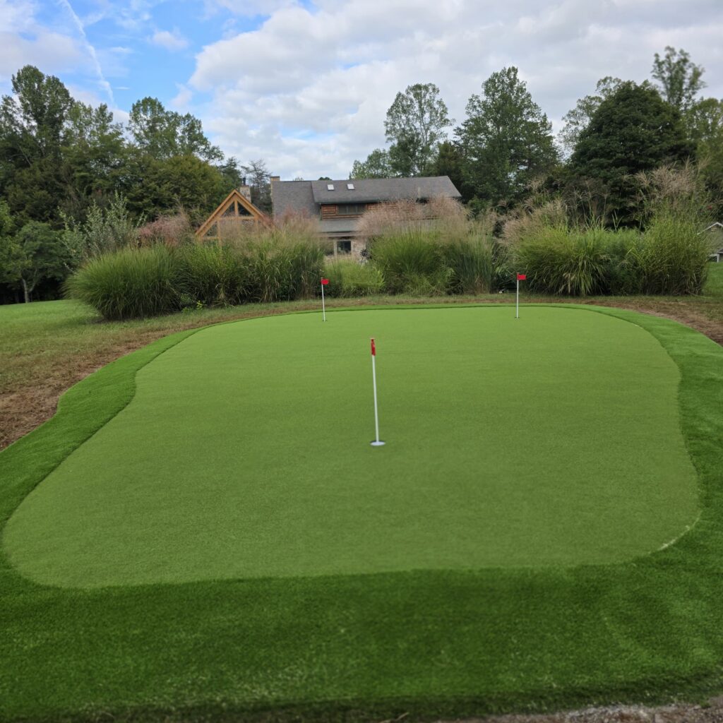 Custom artificial turf putting green with three practice holes and turf fringe